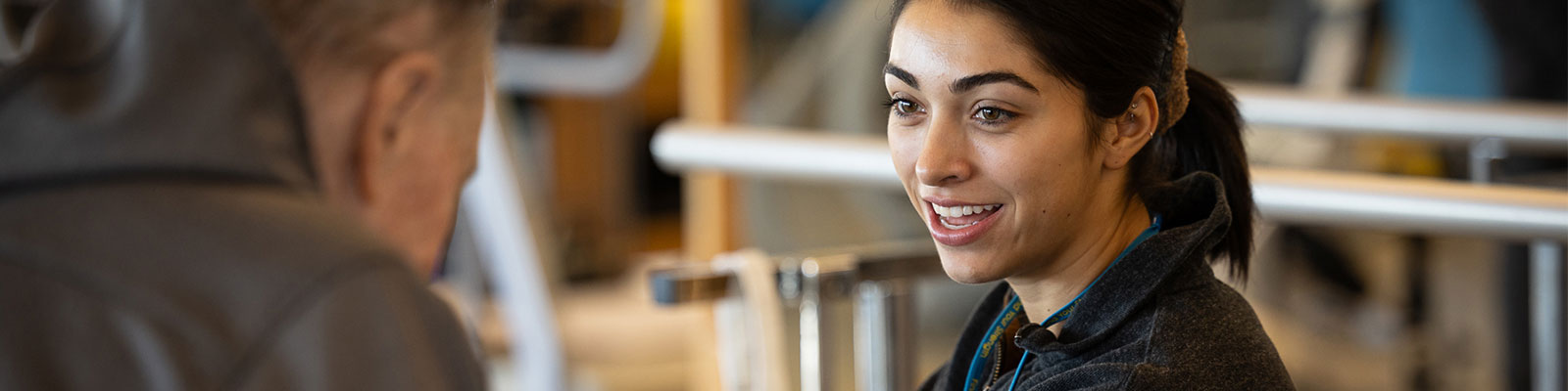 A smiling practitioner talks with a patient.