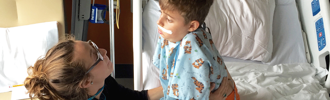 Therapist with a small boy in Tigger pajamas