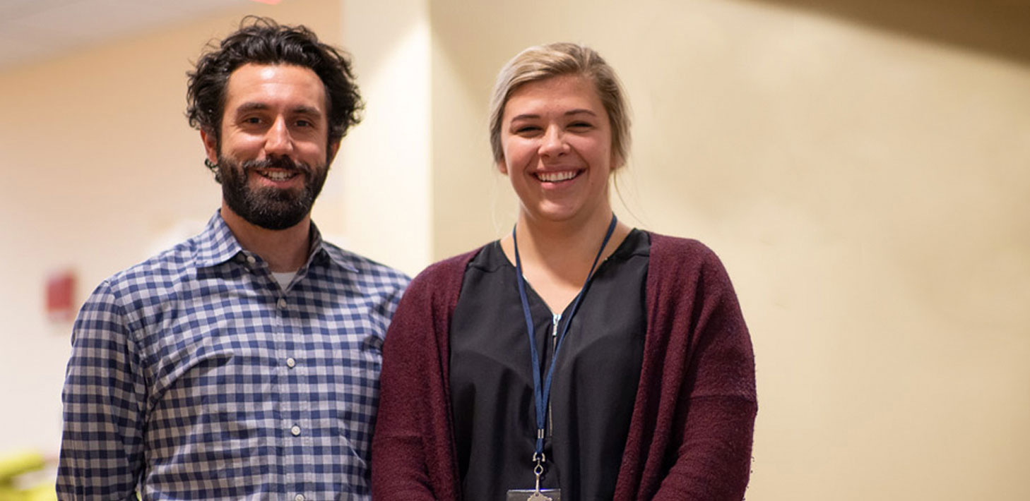 a man and woman smiling in a hallway