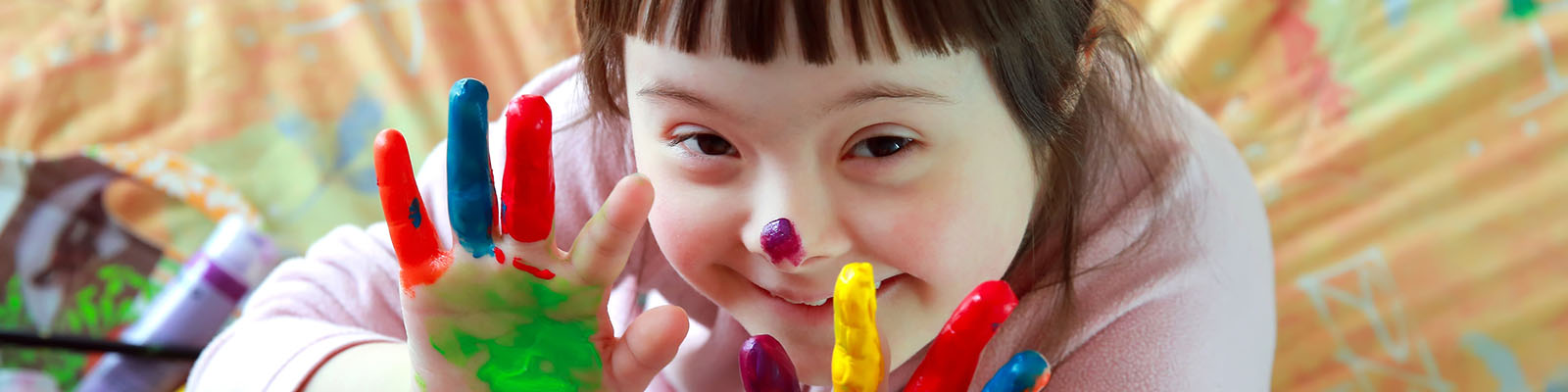 A child plays with finger paints.
