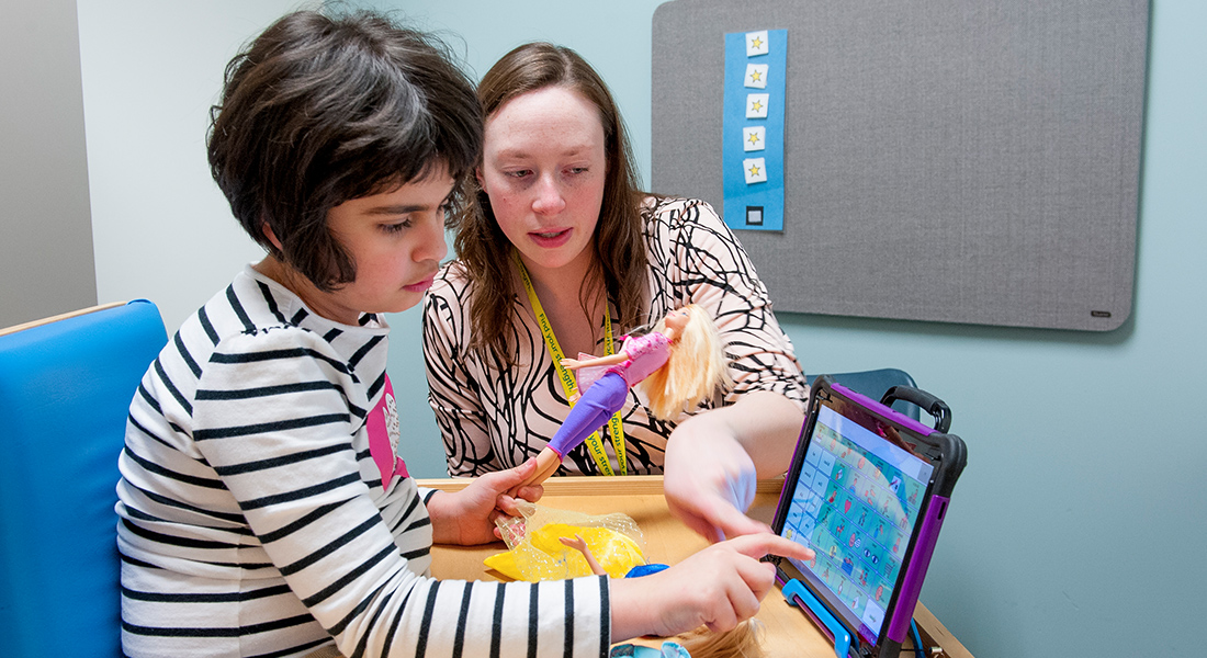 Patient rehabbing on tablet with nurse