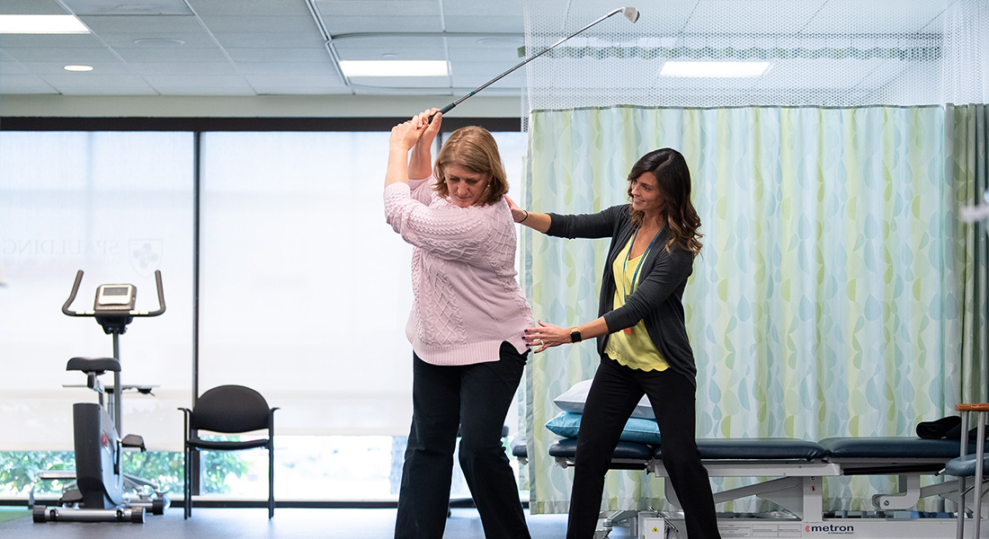 Patient rhabbing golf swing at Spaulding Outpatient Center Malden
