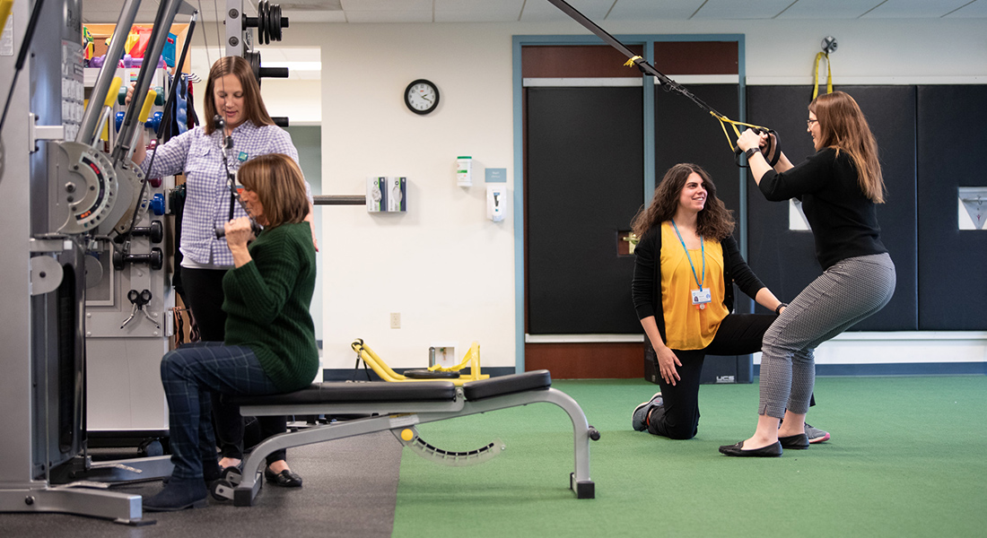 Patients using rehab equipment at Spaulding Outpatient Center Malden