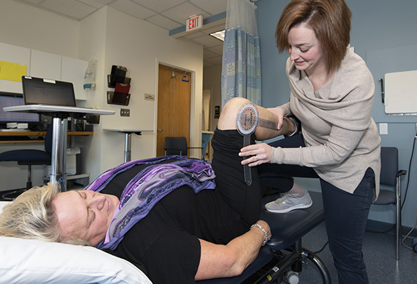 Spaulding team member assisting patient