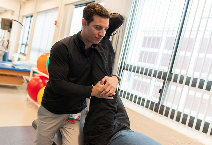 Salem Outpatient team member assisting patient with rehab