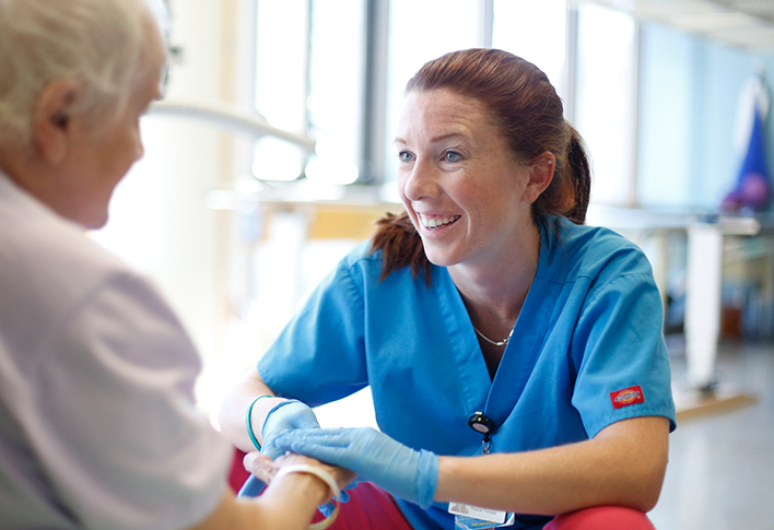 Spaulding team member assisting patient