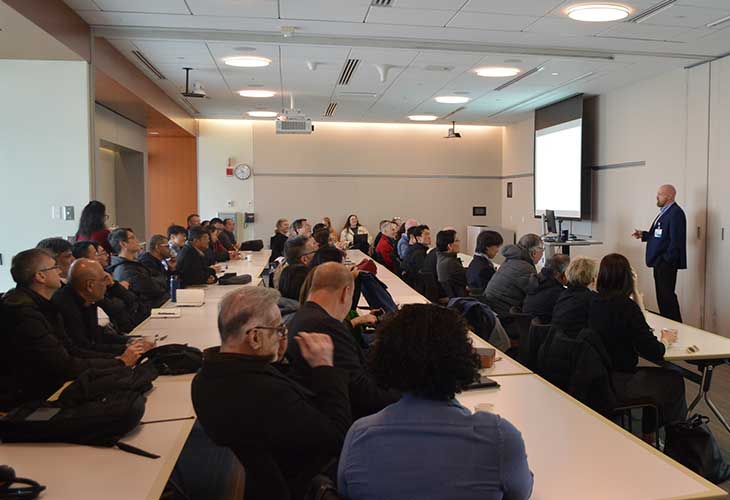 Delegation members watch a presentation by a Spaulding researcher.