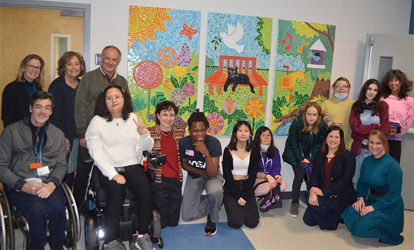 The program participants posed in front of the new mosaic.