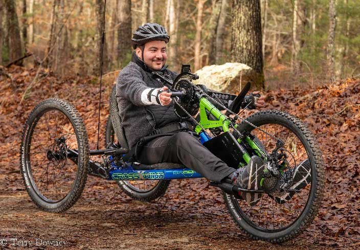 Chris on a path in the woods on his modified bicycle.