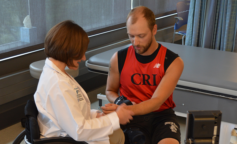 Dr. Blauwet with patient in clinic